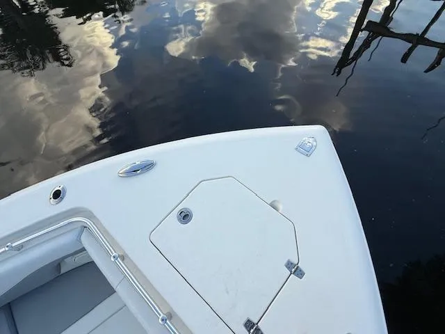  Yacht Photos Pics 2018 Cobia 320 CC boat bow on reflective water surface.