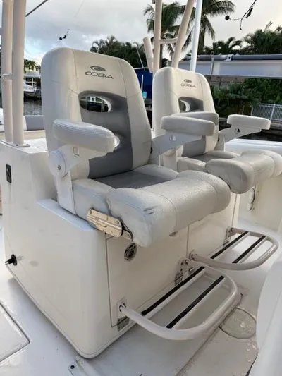  Yacht Photos Pics 2018 Cobia 320 CC boat with cushioned helm seats and footrests.