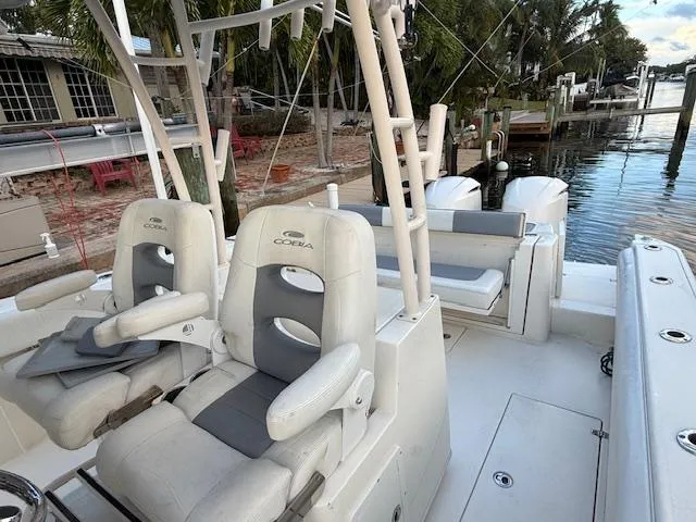  Yacht Photos Pics 2018 Cobia 320 CC boat interior with dual seats and waterfront view.