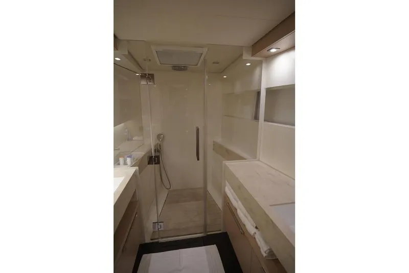  Yacht Photos Pics Modern bathroom interior of 2022 Lagoon 50 yacht with glass shower enclosure.