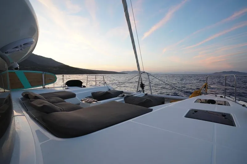  Yacht Photos Pics Luxurious Lagoon 50 catamaran deck at sunset, 2022 model, with ocean view.