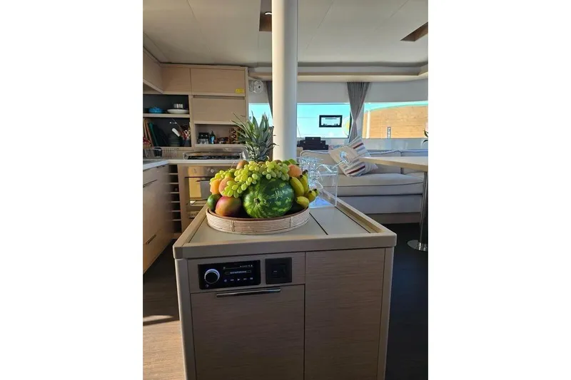  Yacht Photos Pics Interior of 2022 Lagoon 50 yacht with fruit basket on kitchen counter.