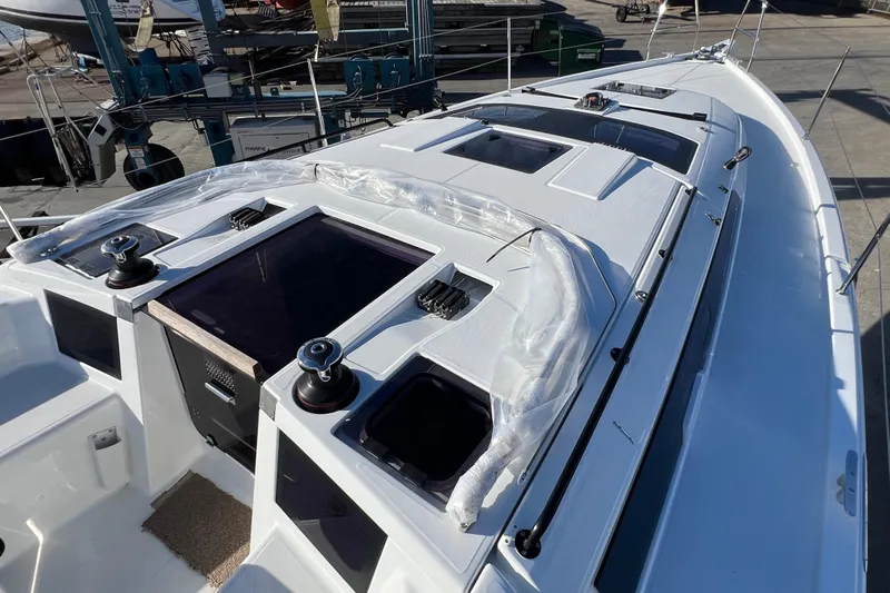  Yacht Photos Pics 2026 Dufour 37 yacht deck with winches and hatches in a marina setting.