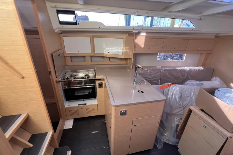  Yacht Photos Pics Interior of 2026 Dufour 37 yacht, featuring modern kitchen and seating area.
