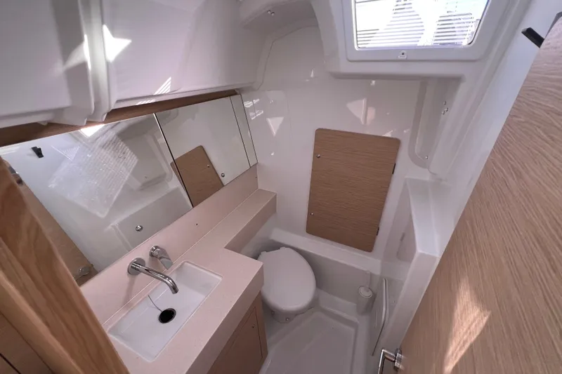  Yacht Photos Pics Modern bathroom interior of 2026 Dufour 37 yacht with sink, toilet, and mirror.