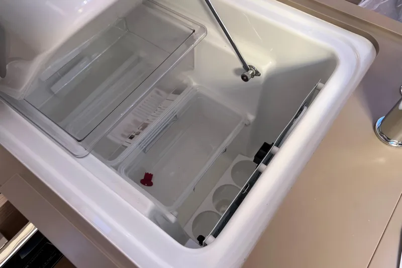  Yacht Photos Pics 2026 Dufour 37 yacht interior fridge with open lid and storage compartments.