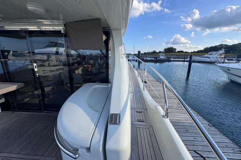  Yacht Photos Pics 2006 Azimut 68S yacht docked at marina, showcasing sleek design and spacious deck.