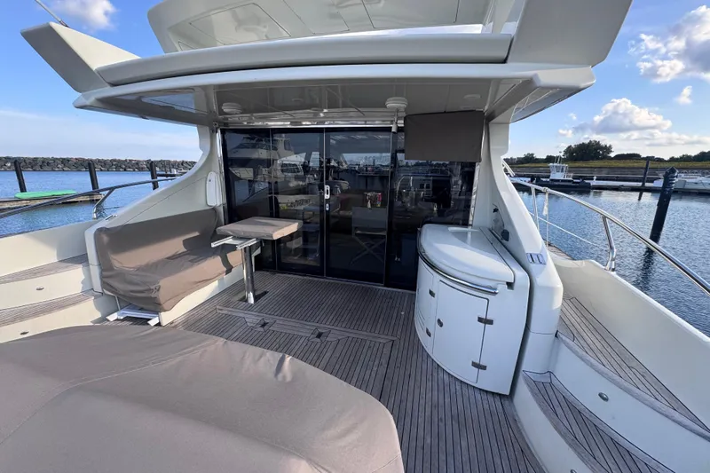  Yacht Photos Pics Luxurious 2006 Azimut 68S yacht deck with seating and marina view.