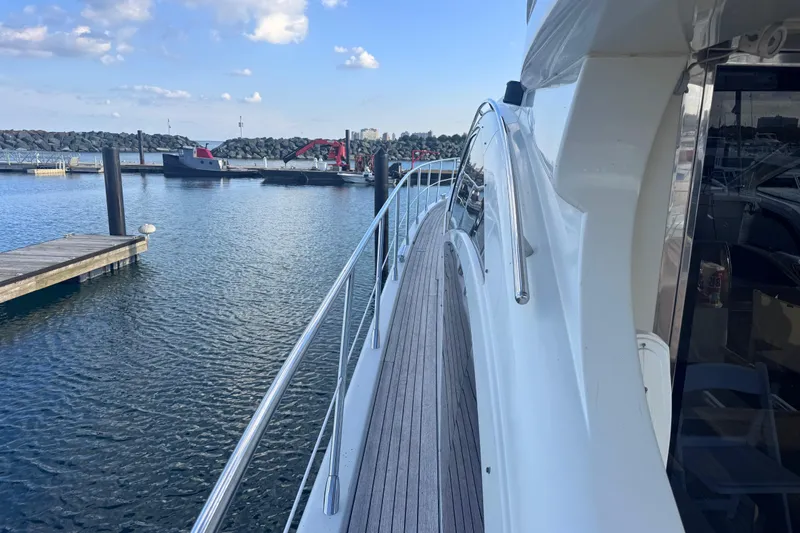  Yacht Photos Pics Azimut 68S 2006 yacht docked at marina, showcasing sleek design and waterfront view.