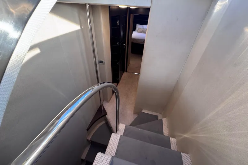  Yacht Photos Pics Staircase leading to a bedroom in a 2006 Azimut 68S yacht interior.