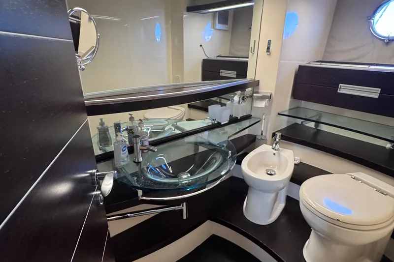  Yacht Photos Pics Luxurious bathroom in 2006 Azimut 68S yacht with modern fixtures and glass sink.