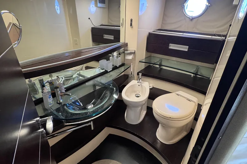  Yacht Photos Pics Luxurious bathroom in 2006 Azimut 68S yacht with modern fixtures and glass sink.