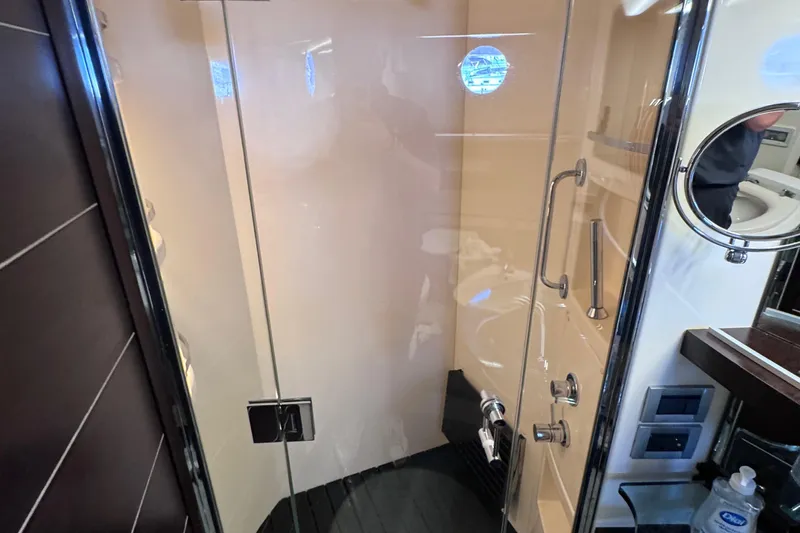  Yacht Photos Pics Luxurious bathroom shower in a 2006 Azimut 68S yacht, featuring glass door and modern fixtures.