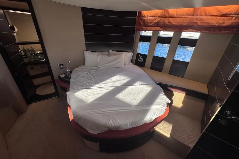  Yacht Photos Pics Luxurious bedroom interior of 2006 Azimut 68S yacht with round bed and ocean view.