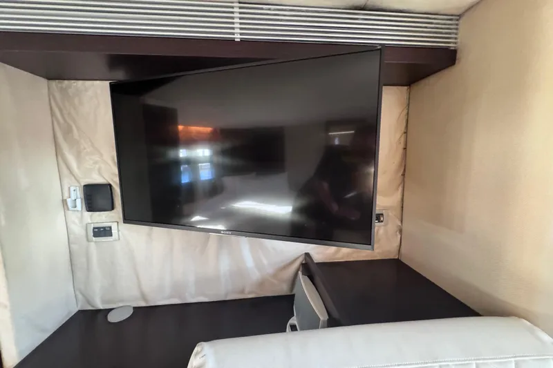  Yacht Photos Pics Flat-screen TV in 2006 Azimut 68S yacht interior, mounted on beige wall.