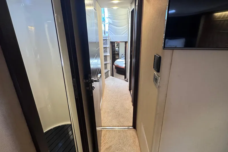  Yacht Photos Pics Interior hallway of 2006 Azimut 68S yacht, featuring modern design and cozy bedroom.