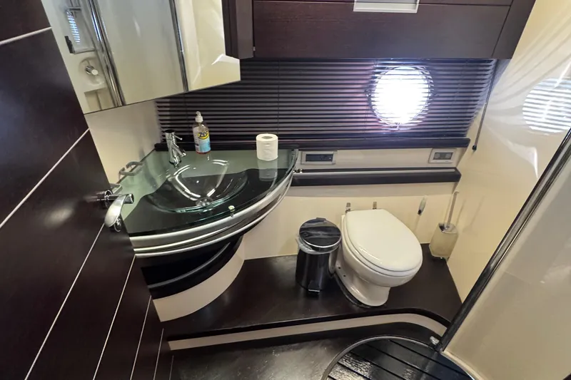  Yacht Photos Pics Luxurious bathroom in 2006 Azimut 68S yacht with modern fixtures and porthole window.