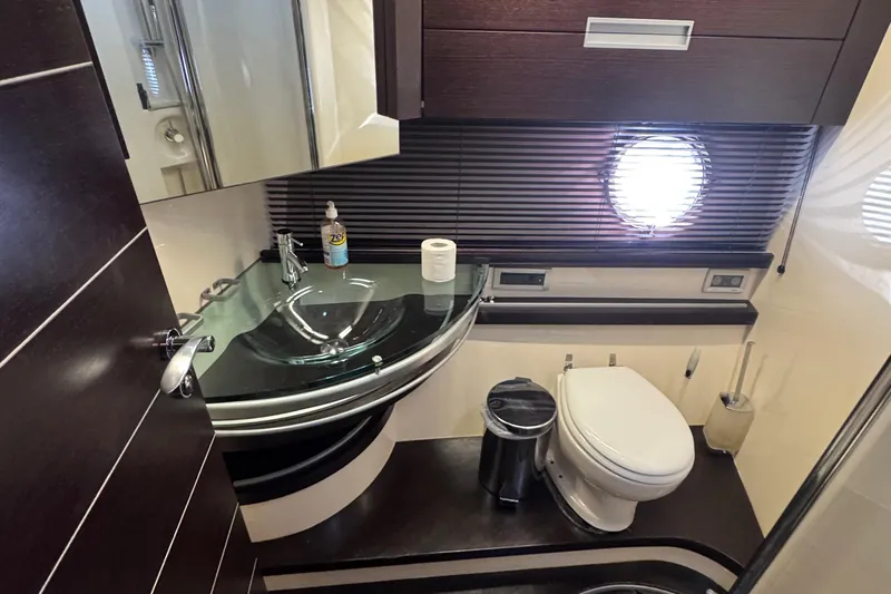 Yacht Photos Pics Luxurious bathroom in a 2006 Azimut 68S yacht with modern fixtures and porthole window.
