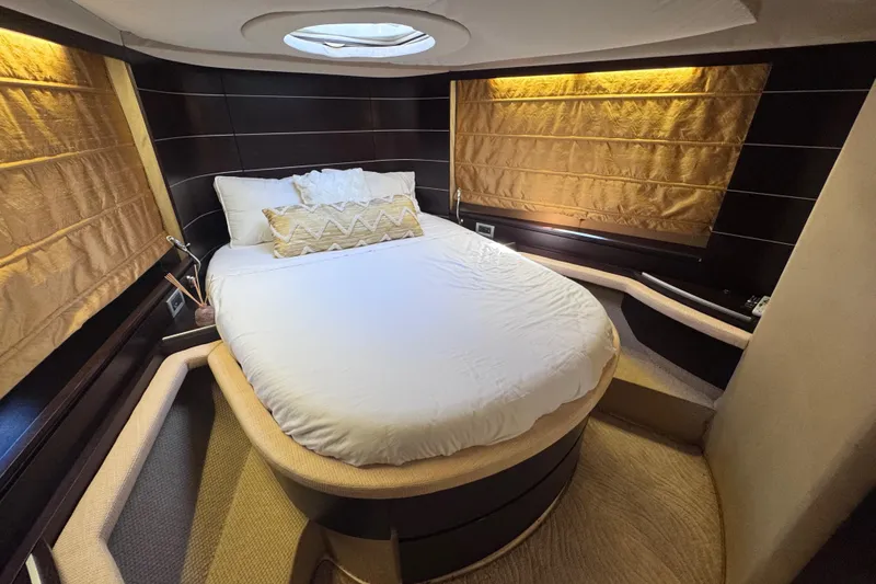  Yacht Photos Pics Luxurious bedroom interior of 2006 Azimut 68S yacht with elegant bedding and ambient lighting.