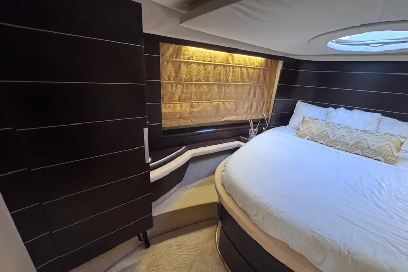 Yacht Photos Pics Luxurious bedroom interior of 2006 Azimut 68S yacht with elegant bedding and ambient lighting.