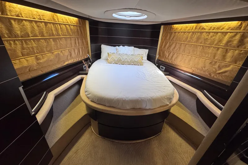 Yacht Photos Pics Luxurious bedroom interior of 2006 Azimut 68S yacht with elegant lighting and cozy bedding.