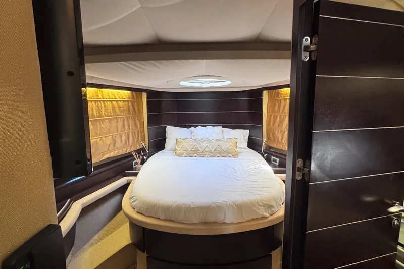  Yacht Photos Pics Luxurious bedroom interior of 2006 Azimut 68S yacht with modern design and cozy bedding.