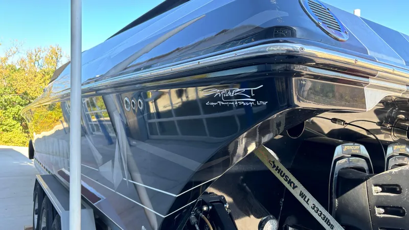  Yacht Photos Pics 2008 Fountain 47 Lightning boat, sleek black exterior, parked outdoors.