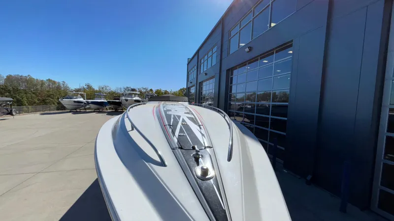  Yacht Photos Pics 2008 Fountain 47 Lightning boat parked outside a modern building under clear blue sky.