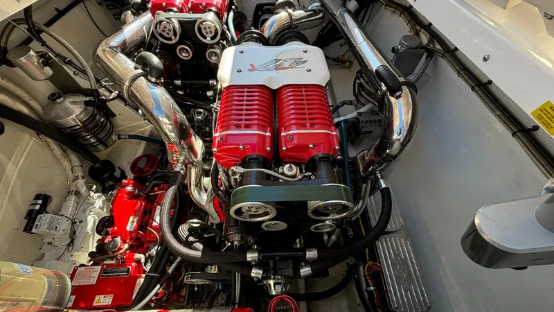  Yacht Photos Pics Engine compartment of a 2008 Fountain 47 Lightning boat, featuring powerful red and chrome components.