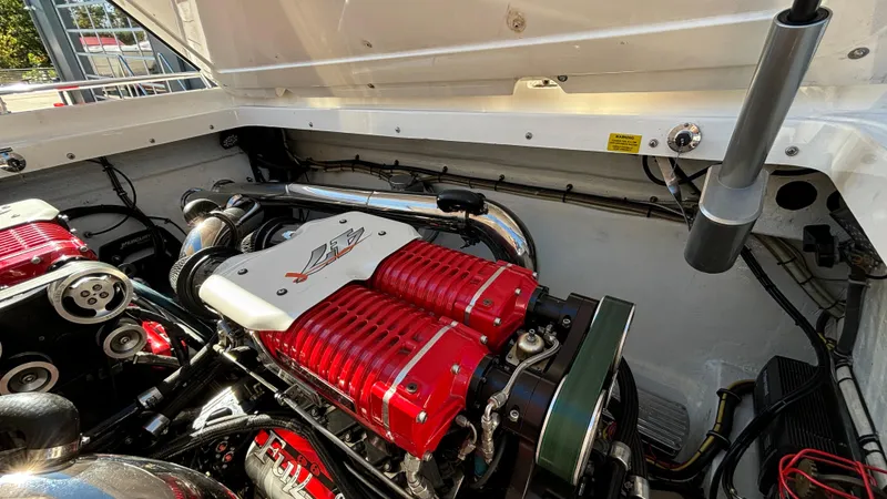  Yacht Photos Pics Engine compartment of a 2008 Fountain 47 Lightning boat, showcasing powerful red engine components.