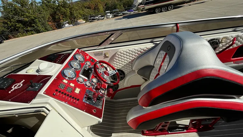  Yacht Photos Pics 2008 Fountain 47 Lightning boat cockpit with red and silver dashboard and seating.