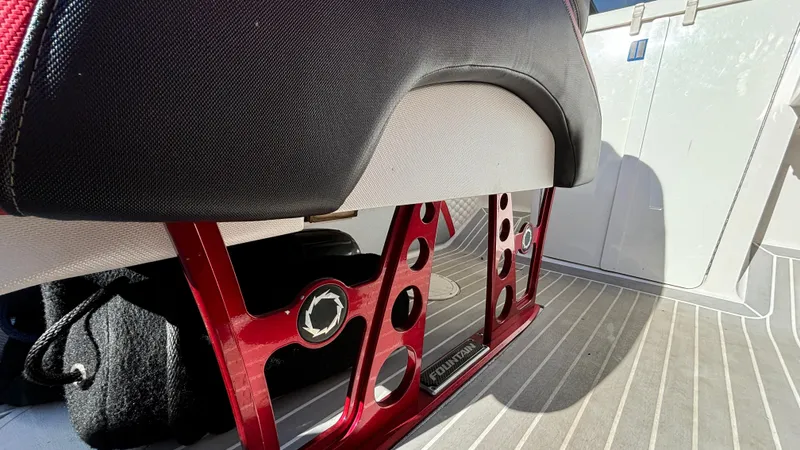  Yacht Photos Pics 2008 Fountain 47 Lightning boat interior with red metal seat support and striped flooring.