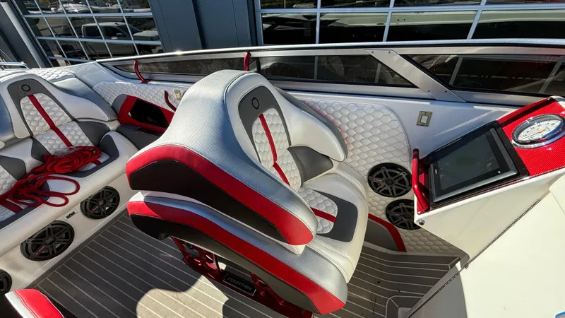  Yacht Photos Pics 2008 Fountain 47 Lightning boat interior with red and gray seating, dashboard, and speakers.