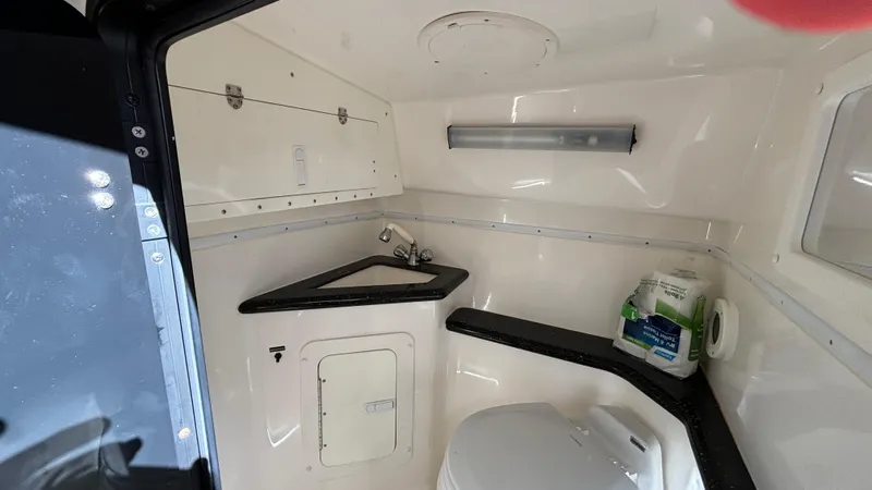  Yacht Photos Pics 2008 Fountain 47 Lightning boat bathroom with sink, toilet, and storage.