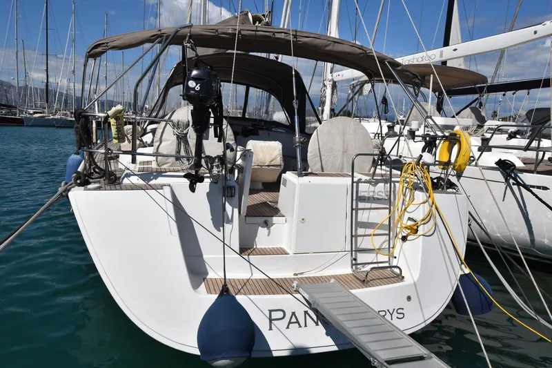 Panope Yacht Photos Pics 2009 Beneteau Oceanis 54 yacht docked at marina, rear view with equipment and ladder.