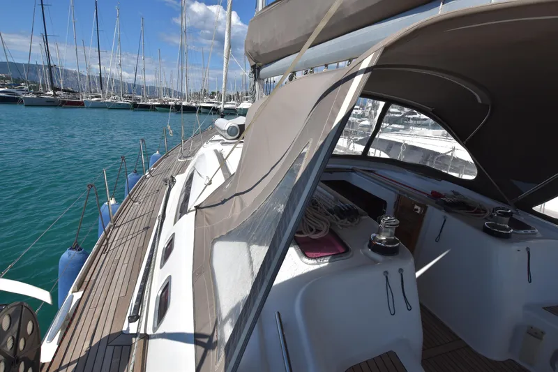 Panope Yacht Photos Pics Beneteau Oceanis 54 sailboat, 2009 model, docked in a marina with clear blue water.