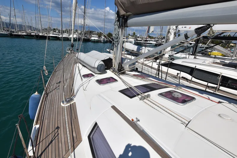 Panope Yacht Photos Pics 2009 Beneteau Oceanis 54 sailboat docked in marina, showcasing deck and rigging.