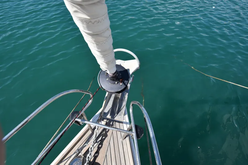 Panope Yacht Photos Pics Bow of 2009 Beneteau Oceanis 54 sailboat with clear blue water.