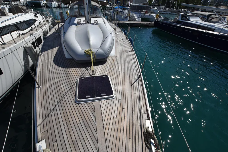 Panope Yacht Photos Pics Deck of 2009 Beneteau Oceanis 54 yacht with inflatable boat, docked in marina.