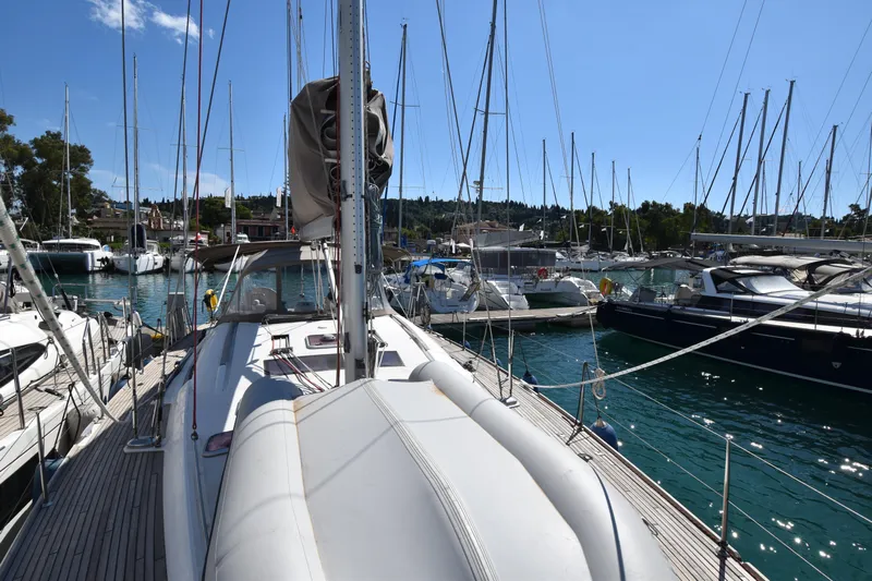 Panope Yacht Photos Pics 2009 Beneteau Oceanis 54 sailboat docked in a marina under clear blue skies.