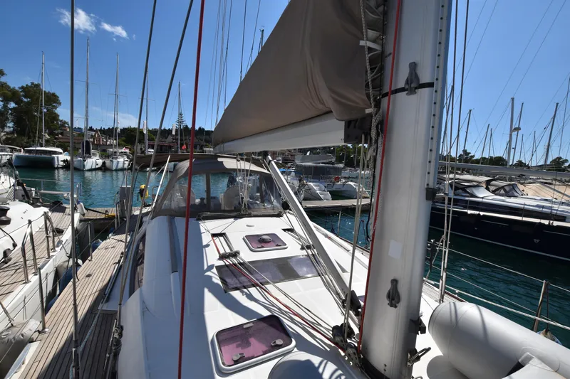Panope Yacht Photos Pics 2009 Beneteau Oceanis 54 sailboat docked in a marina, surrounded by other yachts.