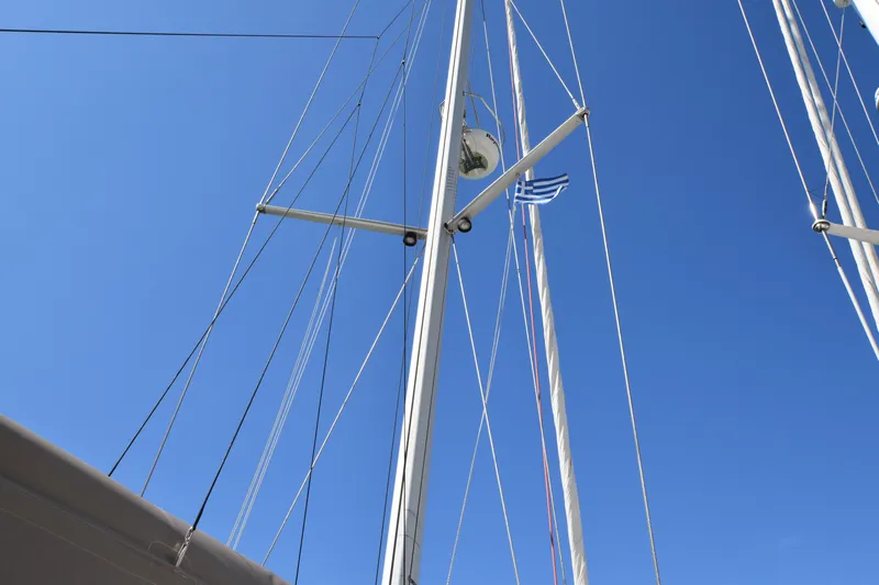 Panope Yacht Photos Pics Mast of 2009 Beneteau Oceanis 54 sailboat against clear blue sky.