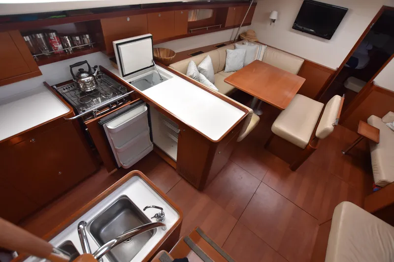 Panope Yacht Photos Pics Interior of 2009 Beneteau Oceanis 54 yacht with kitchen and dining area.
