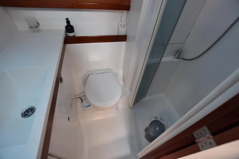 Panope Yacht Photos Pics Compact bathroom in 2009 Beneteau Oceanis 54 yacht with toilet and shower.