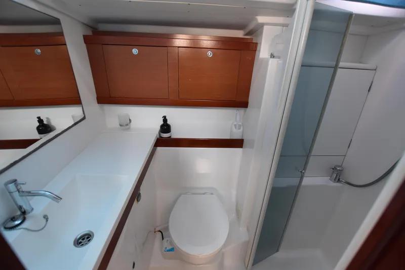 Panope Yacht Photos Pics Bathroom of 2009 Beneteau Oceanis 54 yacht with sink, toilet, and shower.