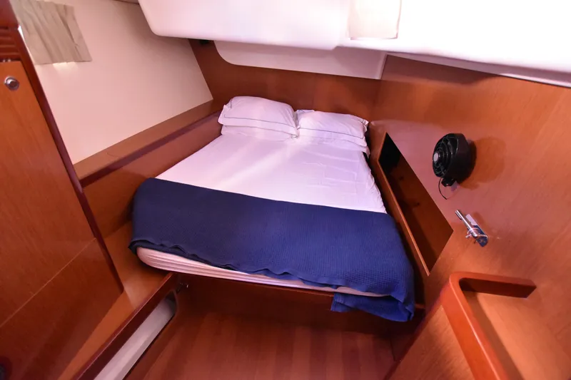 Panope Yacht Photos Pics Cozy cabin interior of 2009 Beneteau Oceanis 54 yacht with bed and wooden furnishings.