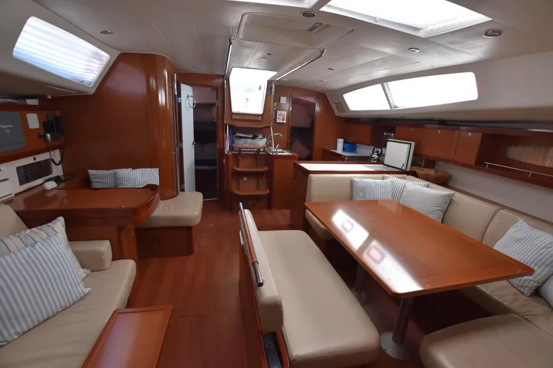 Panope Yacht Photos Pics Luxurious interior of 2009 Beneteau Oceanis 54 yacht with wood finish and seating area.