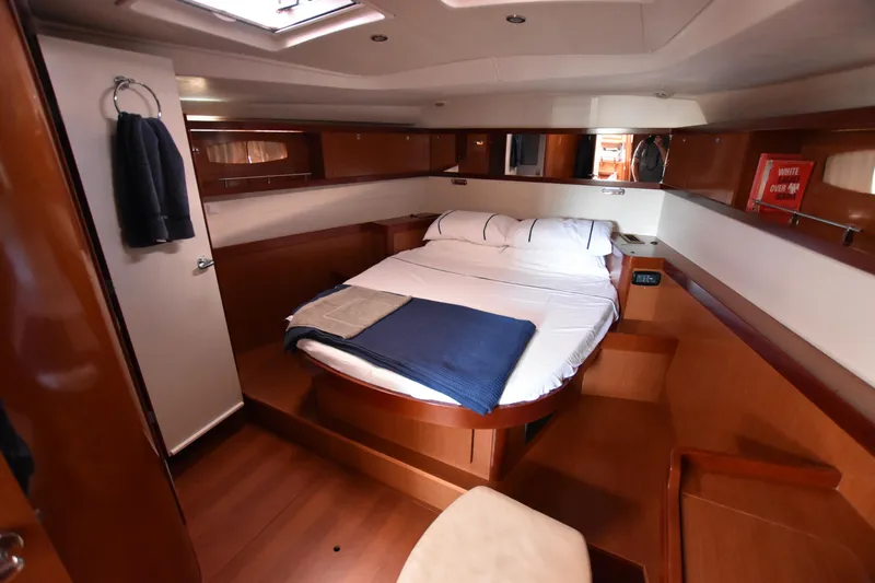 Panope Yacht Photos Pics Luxurious cabin interior of 2009 Beneteau Oceanis 54 yacht with cozy bed and wooden finish.