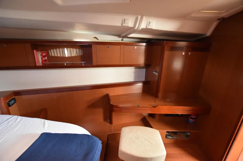 Panope Yacht Photos Pics Interior cabin of 2009 Beneteau Oceanis 54 yacht with wooden cabinetry and seating.
