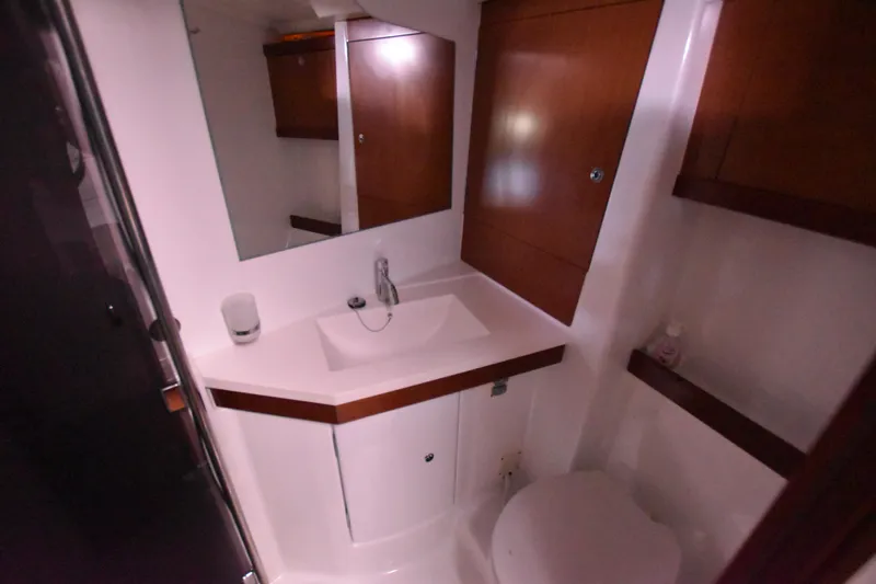 Panope Yacht Photos Pics Bathroom interior of 2009 Beneteau Oceanis 54 yacht with sink and mirror.